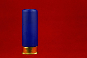 Blue Shotgun Cartridge on a Red Background