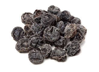 Dried black plums isolated on white background