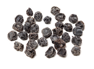 Dried black plums isolated on white background