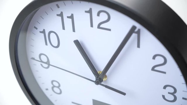 Time lapse of a big clock on a white wall.