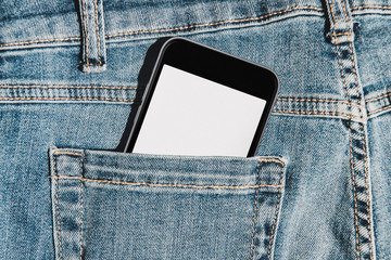 Mobile phone with blank mockup screen in the pocket of blue jeans