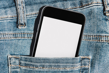 Mobile phone with blank mockup screen in the pocket of blue jeans