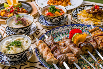 dishes of Uzbek cuisine lagman, pilaf, skewers - obrazy, fototapety, plakaty