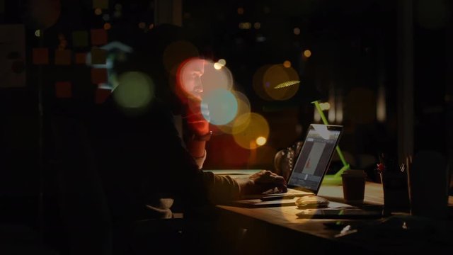 Caucasian man working over laptop by night with bubbble animation