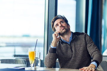 Unhappy businessman with angry face talking on the phone