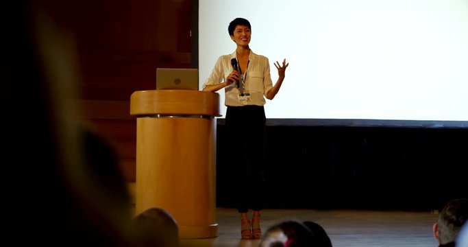 Young Asian businesswoman speaking in business seminar in auditorium 4k