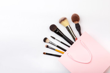 Set of brushes for make up on pink background. Women's secrets. Tools for make up artist with decorative cosmetics