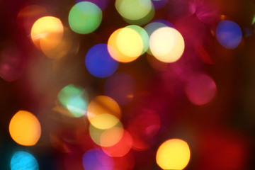 Abstract bokeh background, slightly blurry colored lights, festive city street