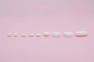 Medical pills in a line ascending