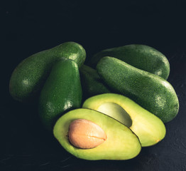 Heap of avocados on wooden table