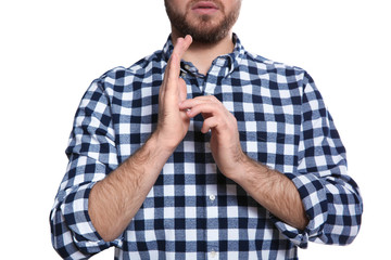Man showing JESUS in sign language on white background, closeup