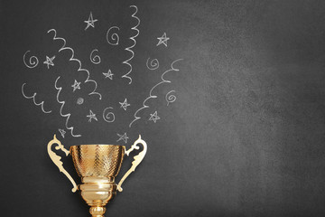 Trophy and chalk drawn confetti salute on black background, space for text. Victory concept