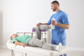 Doctor working with patient in hospital. Rehabilitation physiotherapy