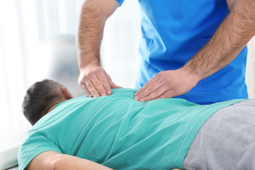 Doctor working with patient in hospital, closeup. Rehabilitation massage