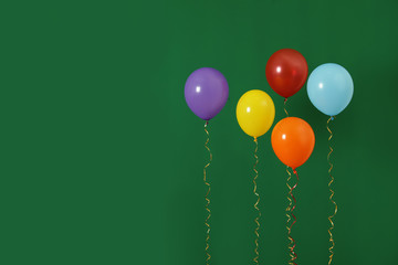 Bright balloons on color background, space for text. Celebration time