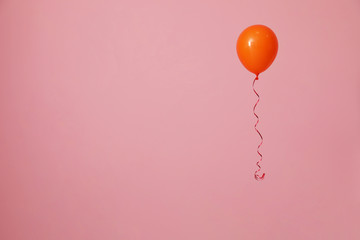 Bright balloon on color background, space for text. Celebration time