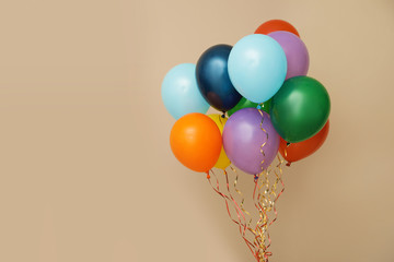 Bunch of bright balloons on color background, space for text. Celebration time