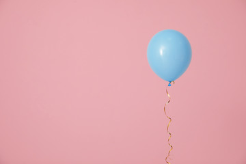 Bright balloon on color background, space for text. Celebration time
