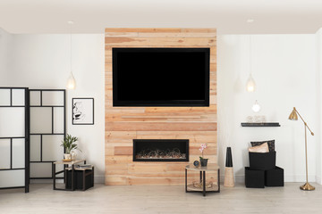 Living room interior with decorative fireplace in wooden wall