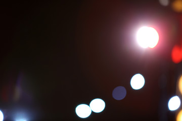 Blurred view of beautiful lights on dark background. Bokeh effect