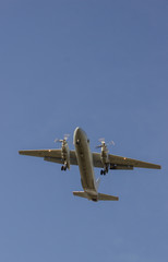 Airplane flying against the sky, bottom view