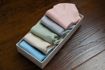 Box of sport socks on wooden background