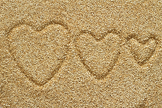 White quinoa seeds background(Chenopodium quinoa) with heart image,organic food, good nutrition for health