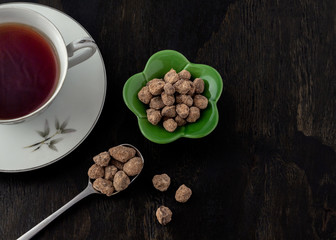 Okinawan black sugar in green flower bowl and spoon
