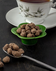 Okinawan black sugar in green flower bowl and spoon