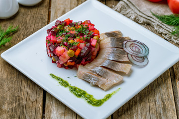 Vinaigrette on a white plate with herring