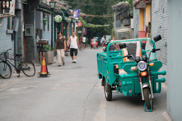 Beijing, China - 08 04 2016: An adult tricycle, bike with three wheels in a hutong, in a street of...