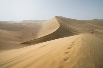 Fototapeta na wymiar Gobi Desert, China - 08 07 2016 : Hike in the Gobi desert. Sand dunes with footprint in the Gobi Desert in China