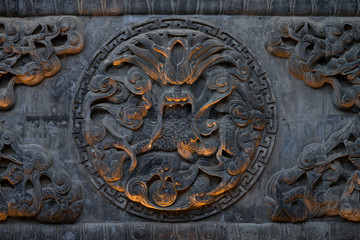 Carving of a Chinese dragon in an octagon on a temple wall in Xi'An, Shaanxi, China