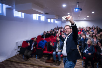 businessman taking selfie at conference room