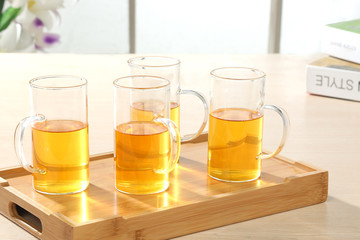 glass of orange juice and fruits on wooden table