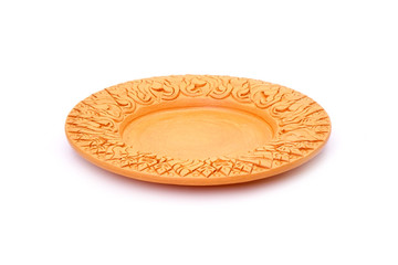 Fototapeta na wymiar Dish / Plate : Thai traditional earthenware dish isolated on white background. Beautiful Flowers carved earthenware from Thailand. Handmade pottery plate.