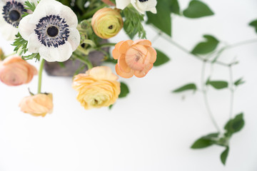 Annemone and Ranunculus floral arrangement flat lay on white background