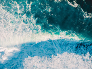 Aerial view of big wave with foam. Blue ocean waves