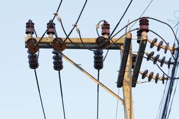 Electricity poles and wires connect to the high voltage power transformer.
