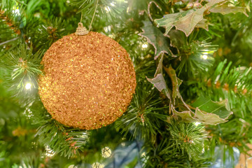 Glittering gold bauble on a Christmas tree in Utah