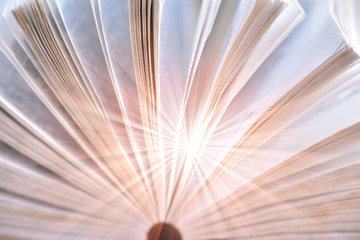 Opened book with the beam of light