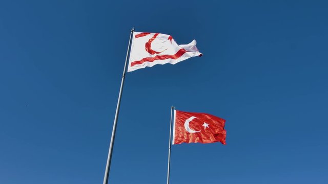 Flags Of Turkey and Turkish Republic of Northern Cyprus together on the wind (slow motion)
