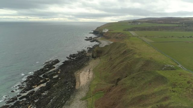Aerial view moving across the headland heading from Dunbeath towards Dunbeath Castle, Caithness, Scotland