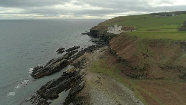 Aerial view moving across the headland heading from Dunbeath towards Dunbeath Castle, Caithness, Scotland