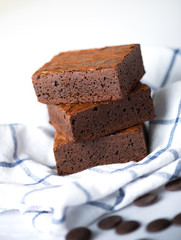 Close up sweet chocolate brownie on tablecloth