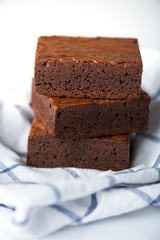 Close up sweet chocolate brownie on tablecloth