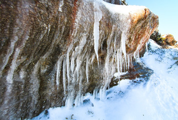 Icicles hang off of a rock wall in the Tongariro National Park, New Zealand.