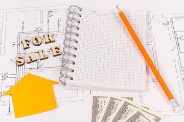 Notepad with pencil and dollar on housing plan, selling and buying house or flat concept