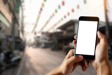 Hand holding white mobile phone with blank white screen  in cafe.