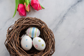 Easter decoration with nest, eggs and spring flowers